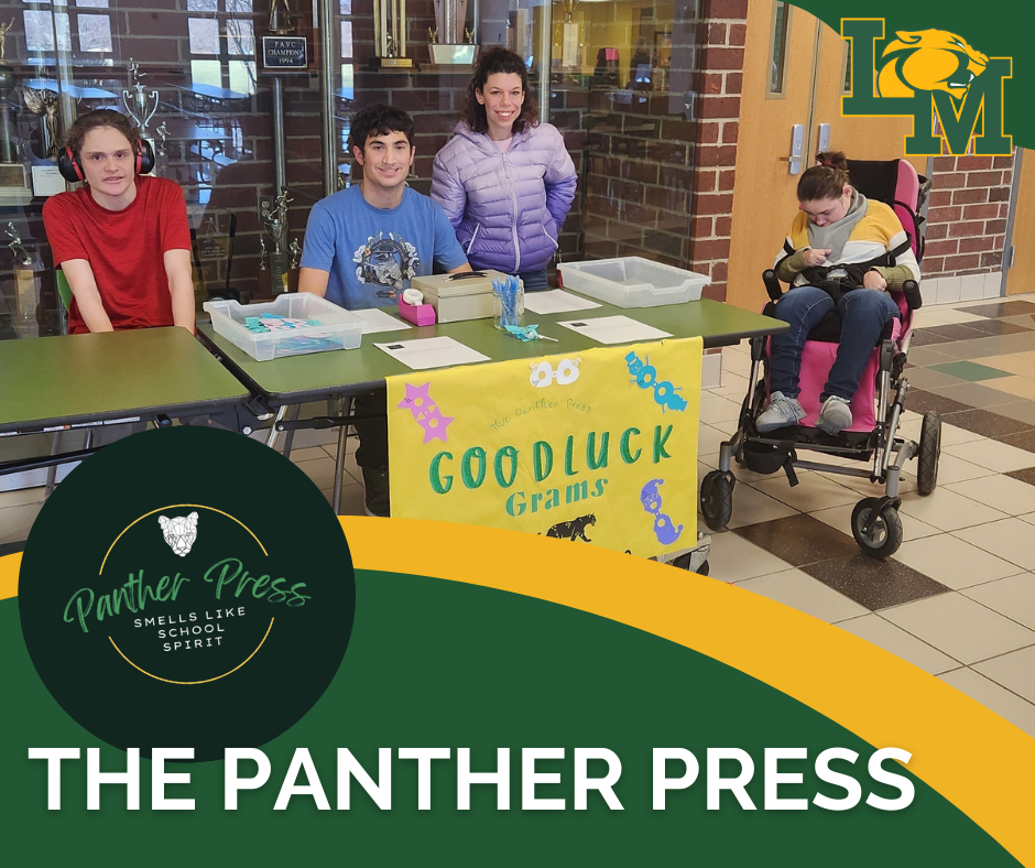 students sitting behind a table selling good luck grams